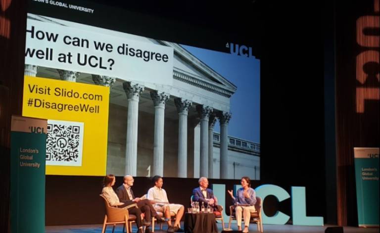 An image from the event titled: Disagreeing Well at С̳. The photo contains 5 panellists sat on chairs on the Bloomsbury Theatre stage.