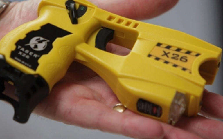 An image of a hand holding a taser